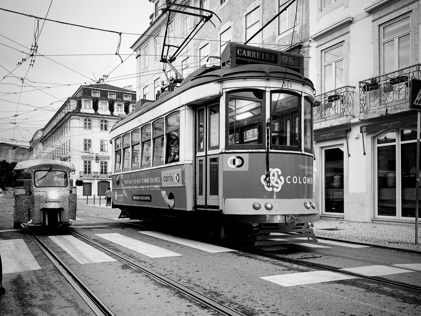 Black and white street photograph of Lisbon with a vintage tram